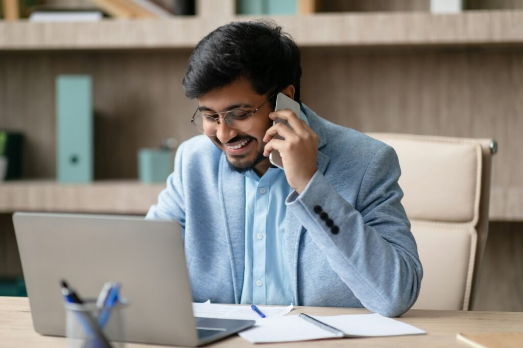 Indian professional man engages in business call in office interior